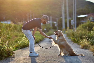 Side view of man with dog