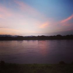 Scenic view of lake against sky at sunset