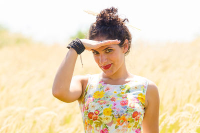 Portrait of smiling young woman standing on land