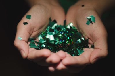 High angle view of woman holding multi colored human hand