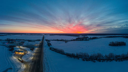 Scenic view of snow against sky during sunset