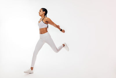 Full length of woman against white background