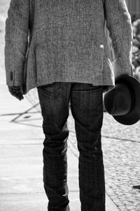 Low section of man standing on street