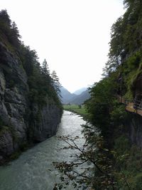 Scenic view of stream by lake against sky