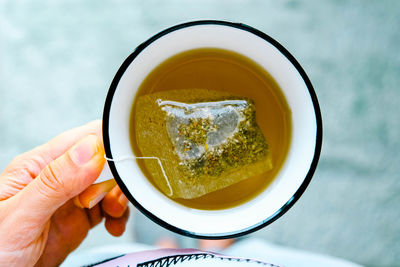 Directly above shot of person holding tea cup