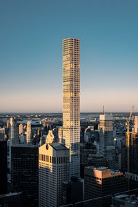 Modern buildings in city against clear sky