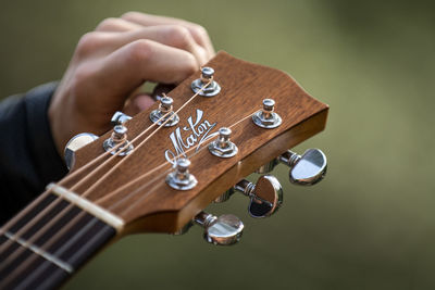 Cropped hand of man playing guitar