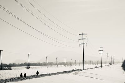 Scenic view of snow covered field against sky