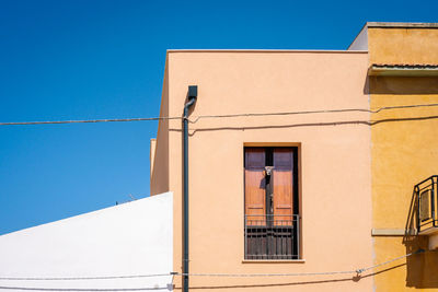 Low angle view of building against clear blue sky