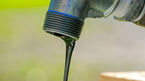 Close-up of water drop from pipe