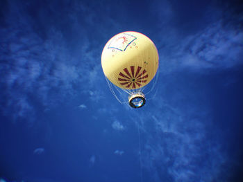 Low angle view of hot air balloon against blue sky