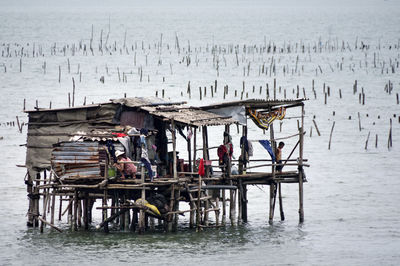 Wooden posts in sea