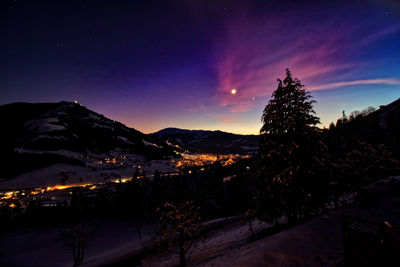 Scenic view of snowcapped mountains against sky at night