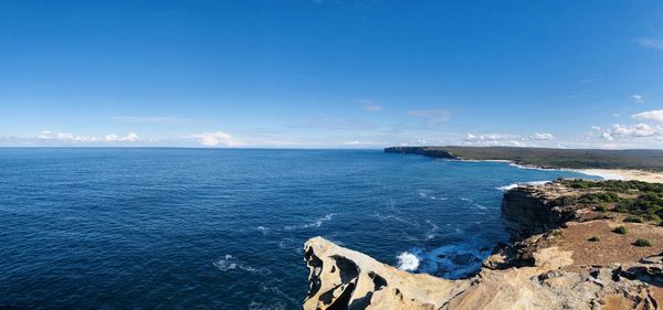 Scenic view of sea against blue sky