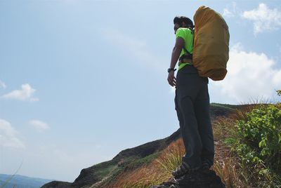 Low angle view of woman standing against sky