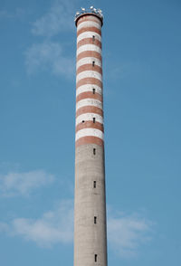 Low angle view of smoke stack against sky