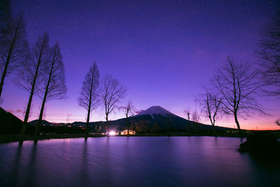 Scenic view of lake against clear sky at night