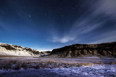 Scenic view of mountains against sky at night
