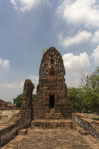 Old ruins of temple against cloudy sky