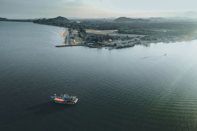 High angle view of city by sea against sky