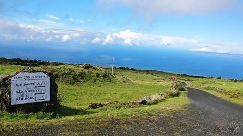 Road by sea against sky