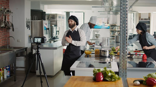 Male chef vlogging in kitchen