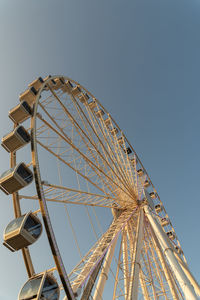 Low angle view of ferris wheel against clear sky