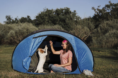 Rear view of man with dog against sky