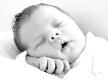 Portrait of baby boy lying on bed