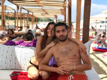 Portrait of couple on sofa at beach