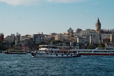 View of sea against buildings in city