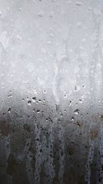 Full frame shot of raindrops on glass window