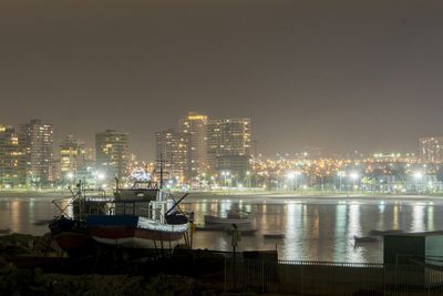 River with illuminated buildings in distance