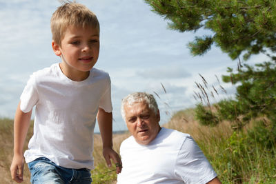 Grandfather with grandson on field