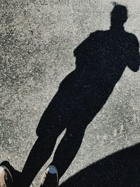 Shadow of man on road