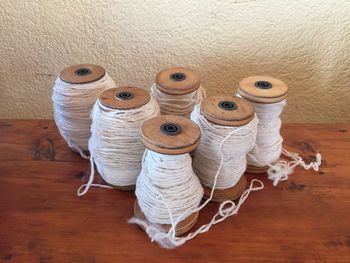 High angle view of spools on table against wall