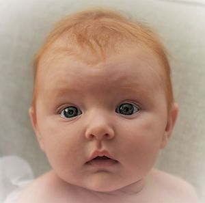 Close-up portrait of cute baby at home