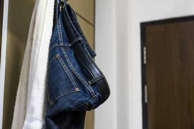 Close-up of jeans hanging at home