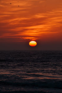 Scenic view of sea against romantic sky at sunset