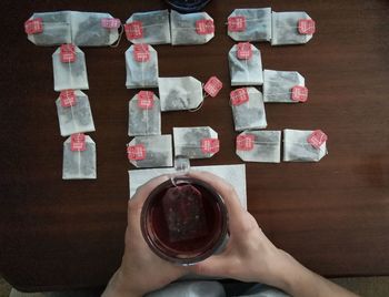 High angle view of hand holding food on table