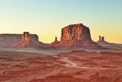 Rock formations on landscape against clear sky