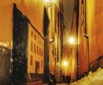 Illuminated street light in city at night