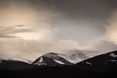 Scenic view of snow covered mountains against sky