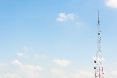 Low angle view of communications tower against blue sky