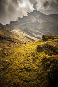 Scenic view of landscape against dramatic sky