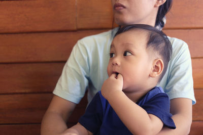 Cute baby boy with mother at home