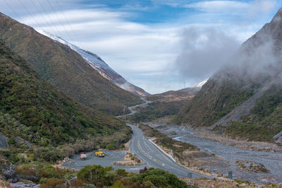 High angle view of road amidst mountains against sky