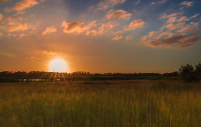 Scenic view of landscape against sky at sunset