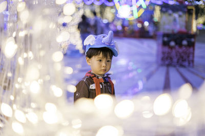 Boy looking away in amusement park