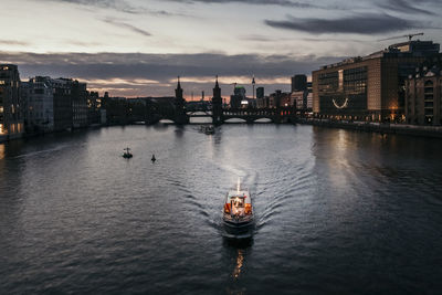 Lighted boat on river at dusk